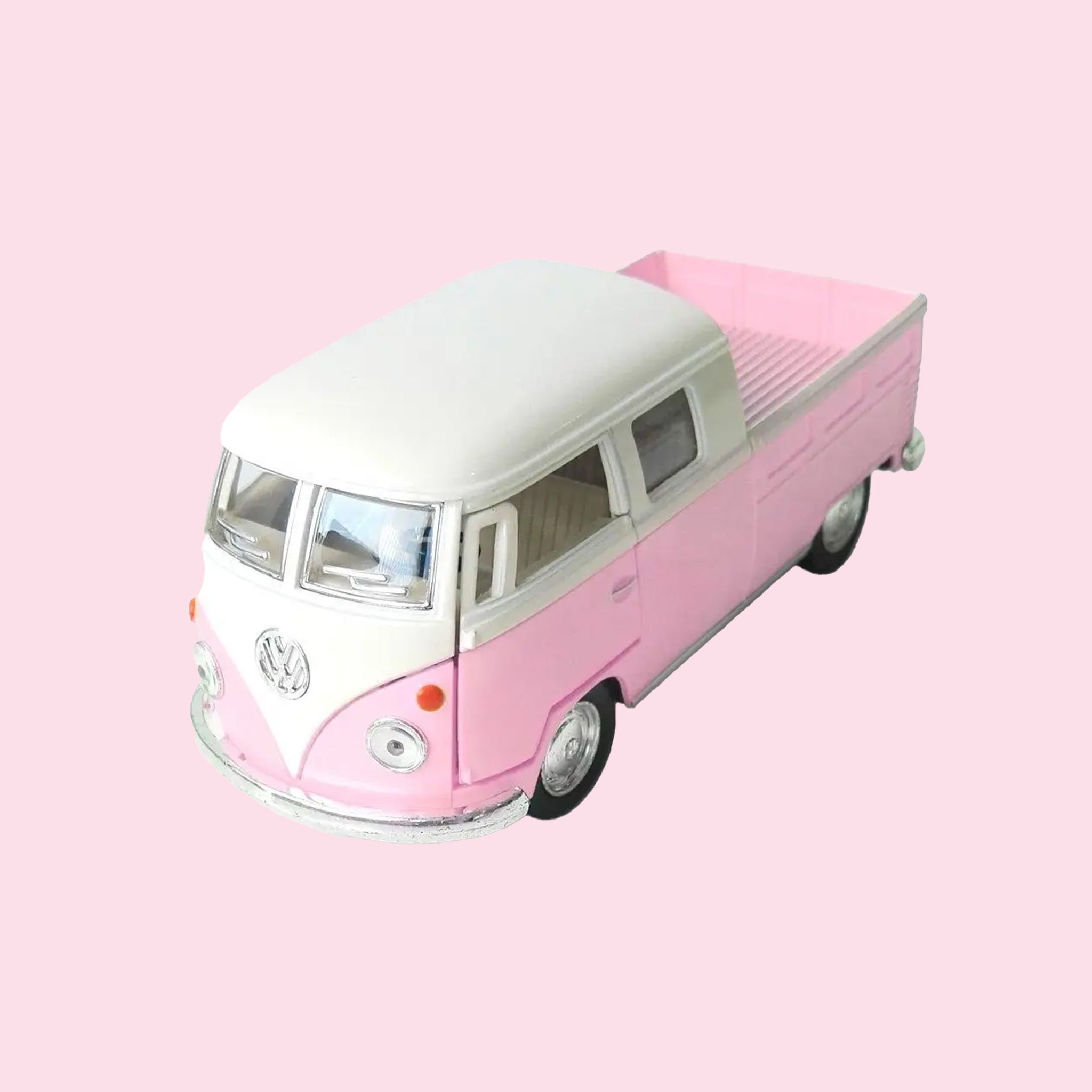 A pink and white VW van truck replica toy. 