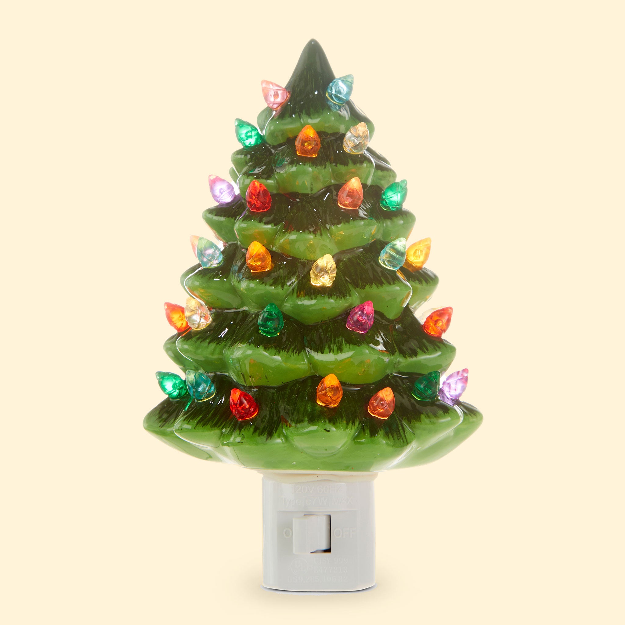 A ceramic green Christmas tree nightlight with multicolored lights all over. There is a white switch on the front of the night light so you can easily turn it on and off.