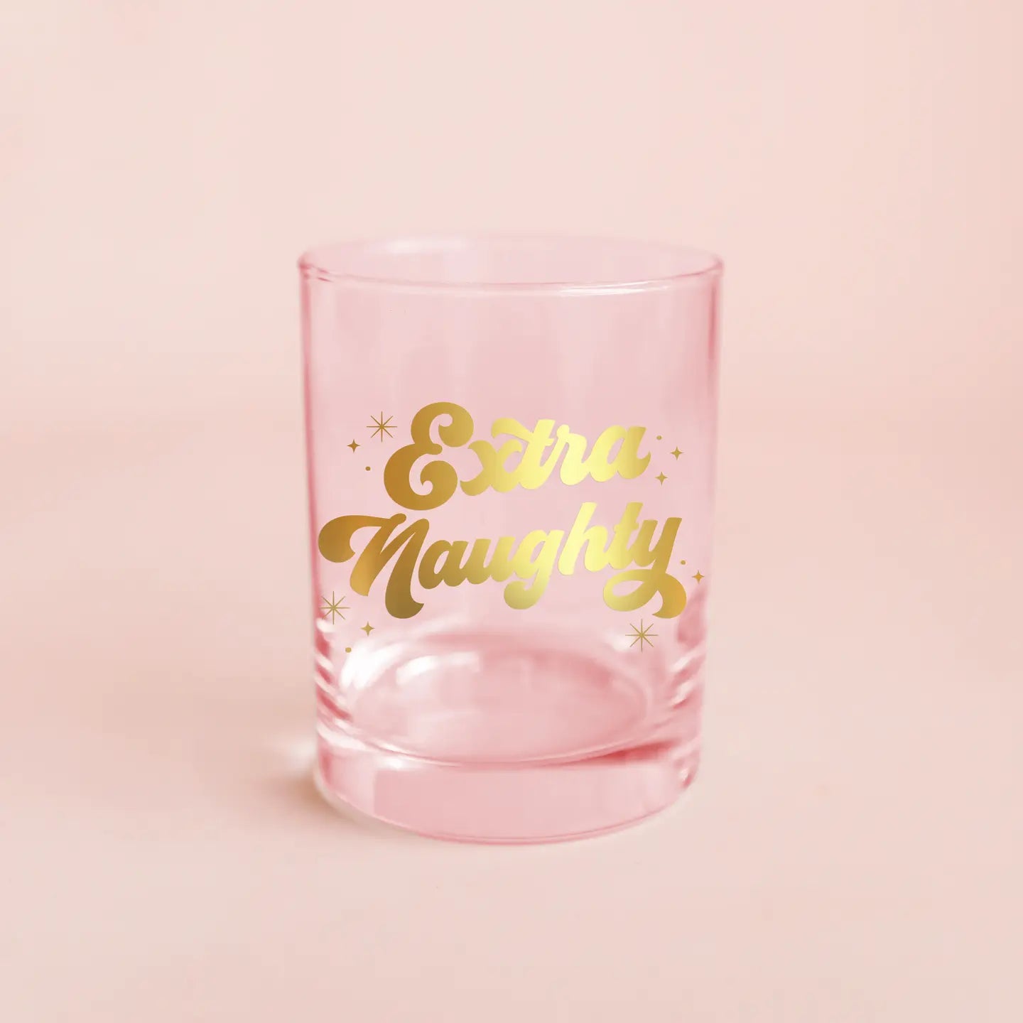 pink glass tumbler with gold script font that says &quot;extra naughty&quot;