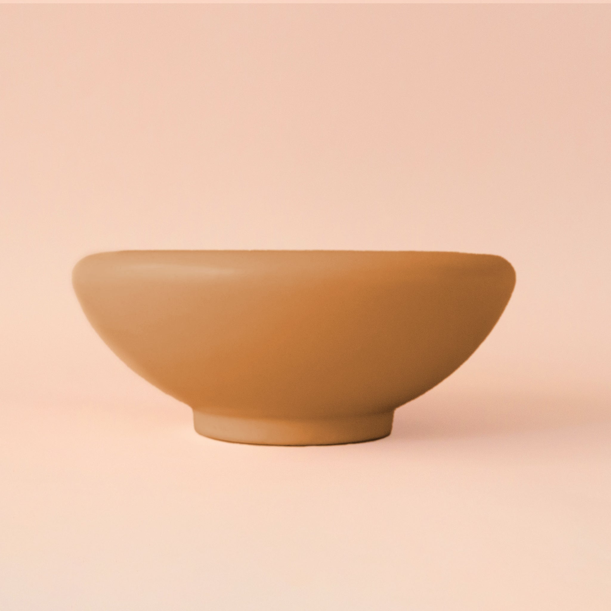 A ginger orange brown ceramic bowl planter. 