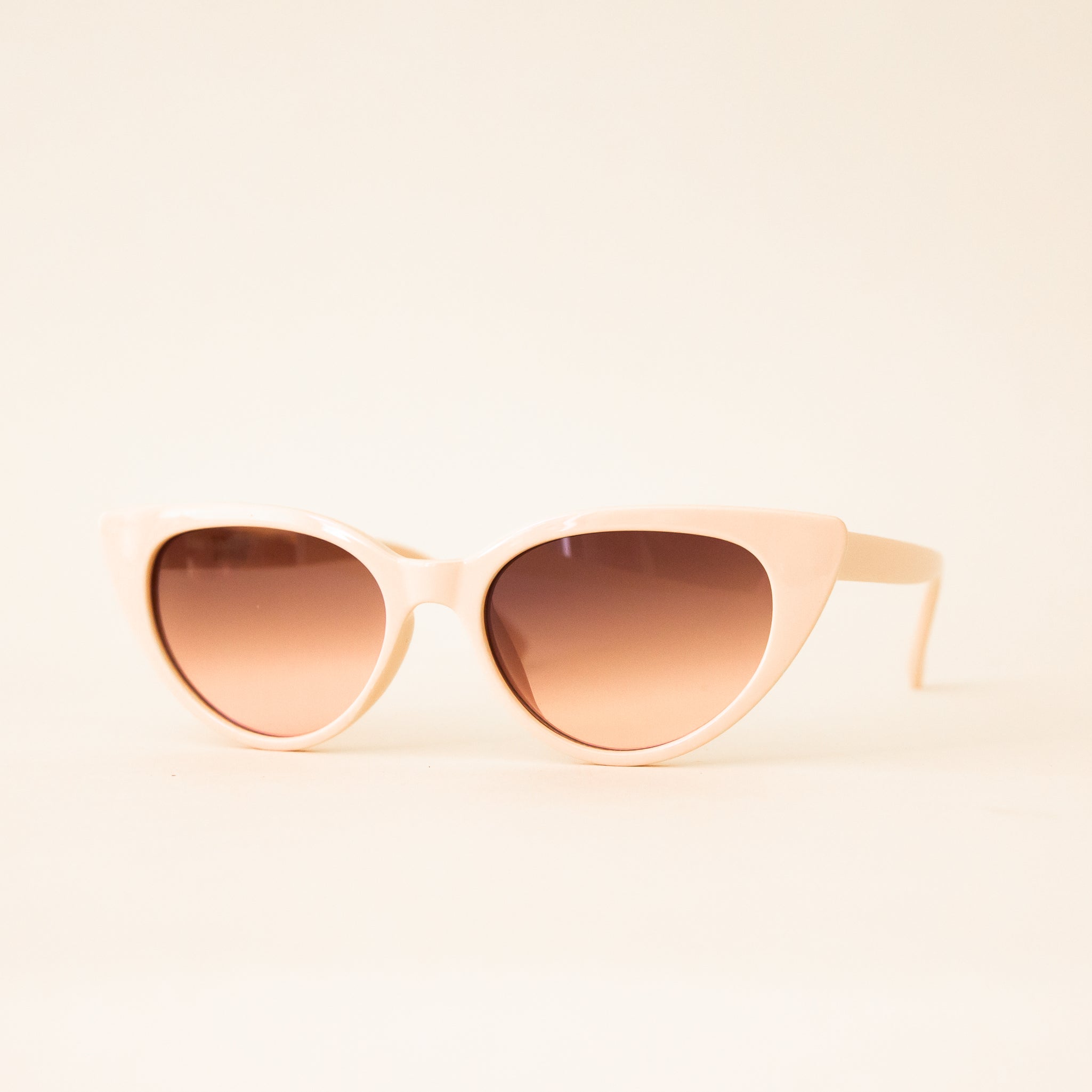 A pair of ivory cat-eye shaped sunglasses