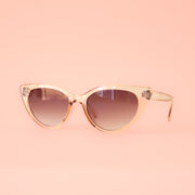 A translucent tan pair of cat-eye shaped sunglasses. 