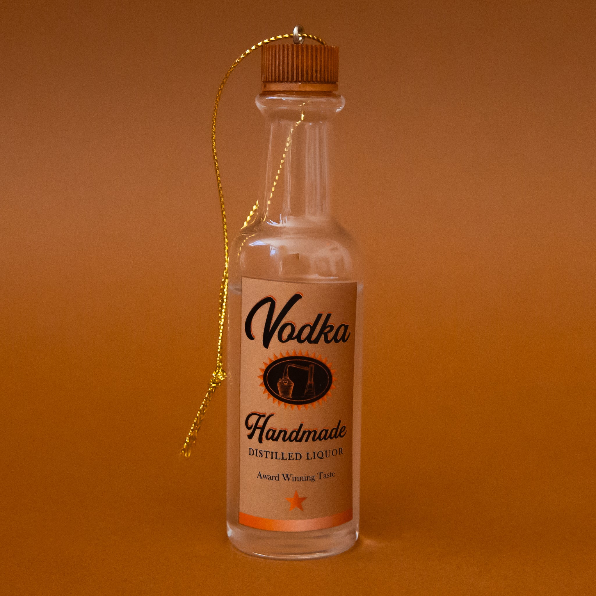 An ornament in the shape of a vodka bottle. 