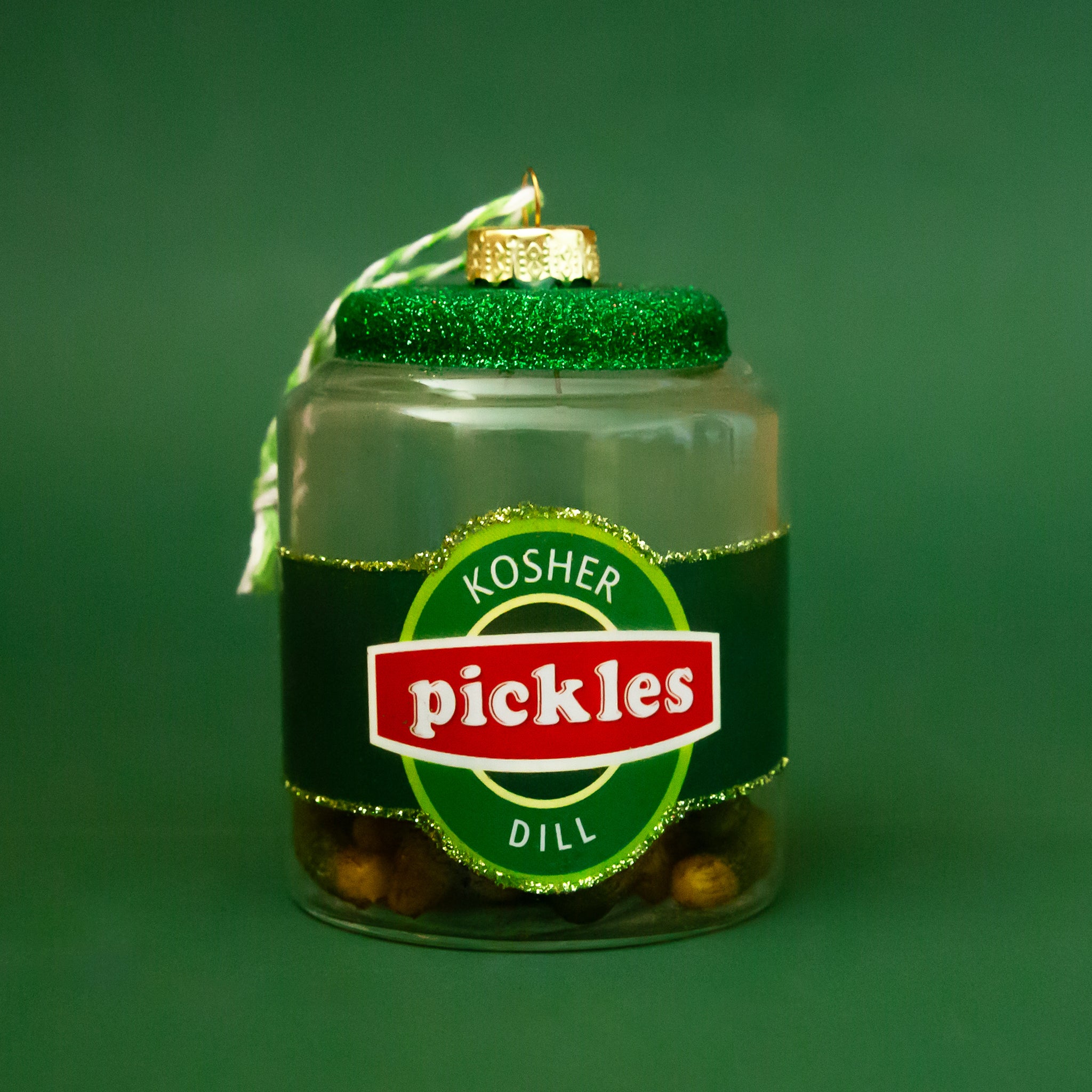 A glass ornament in the shape of a jar of dill pickles. 