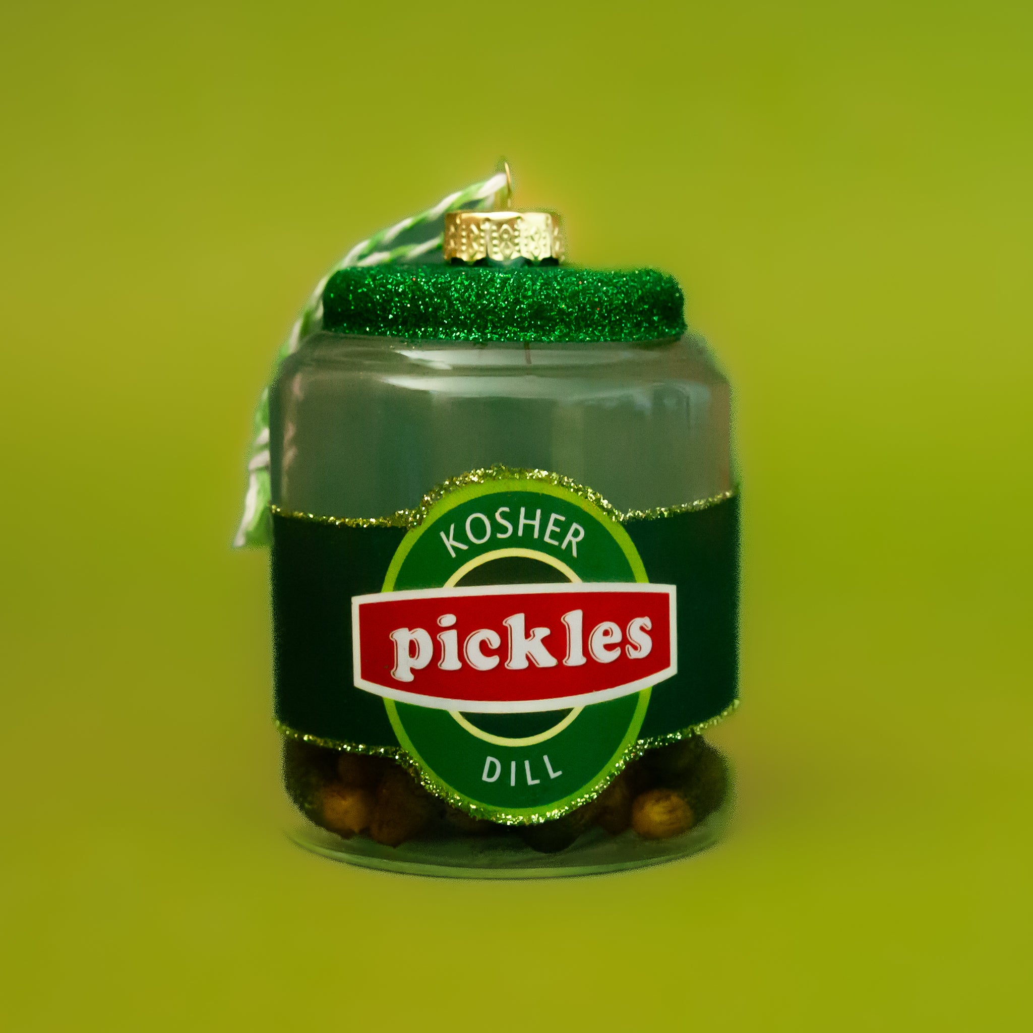 A glass ornament in the shape of a jar of dill pickles. 