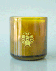 On a blue  background is a green glass jar candle with a logo in the center that reads, "Flamingo Estate".