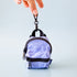 A blue and black mini backpack shaped bag charm. 