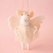 On a light pink background is a white felt mouse ornament with a sparkly gold dress, halo and angel wings. 