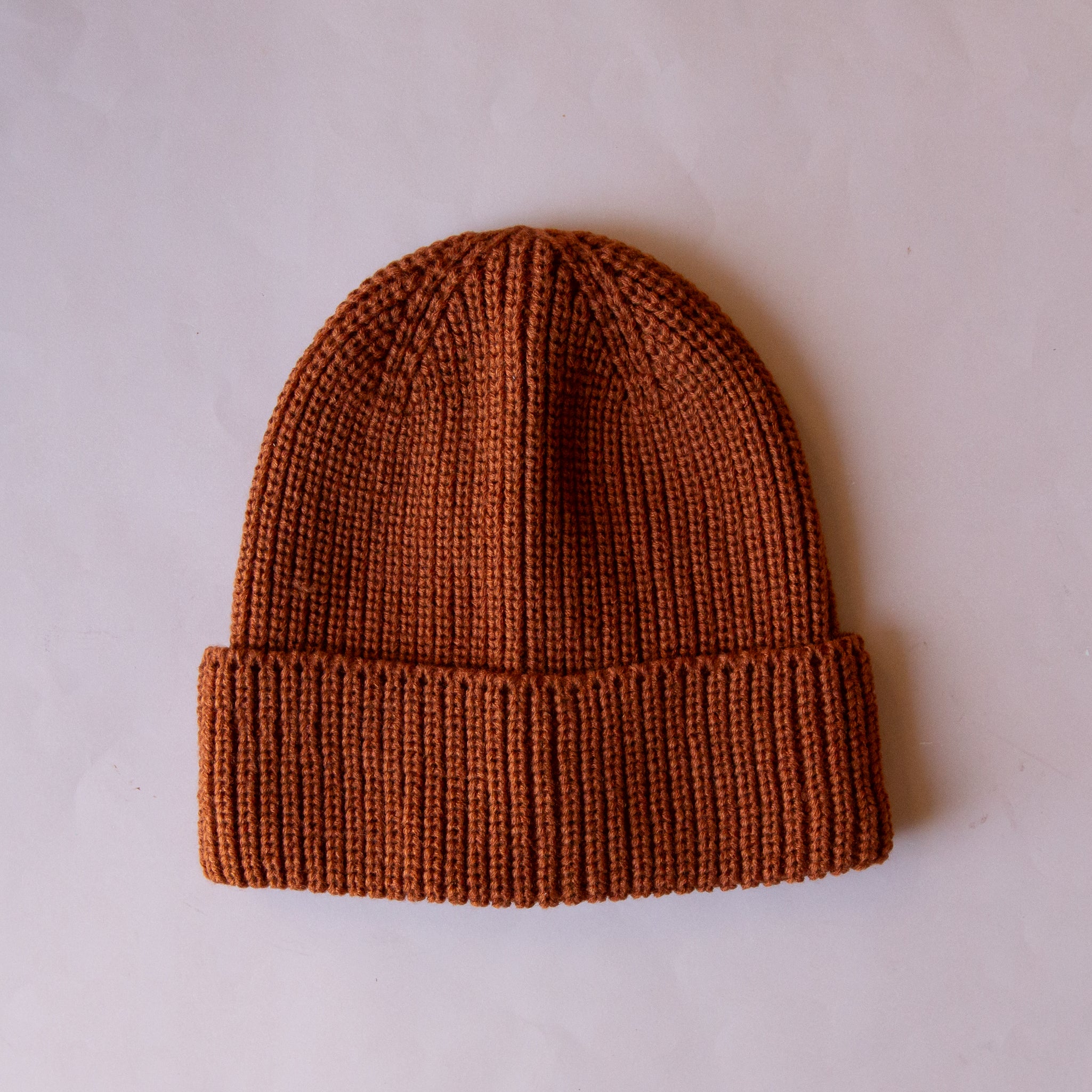 A brown knit beanie. 