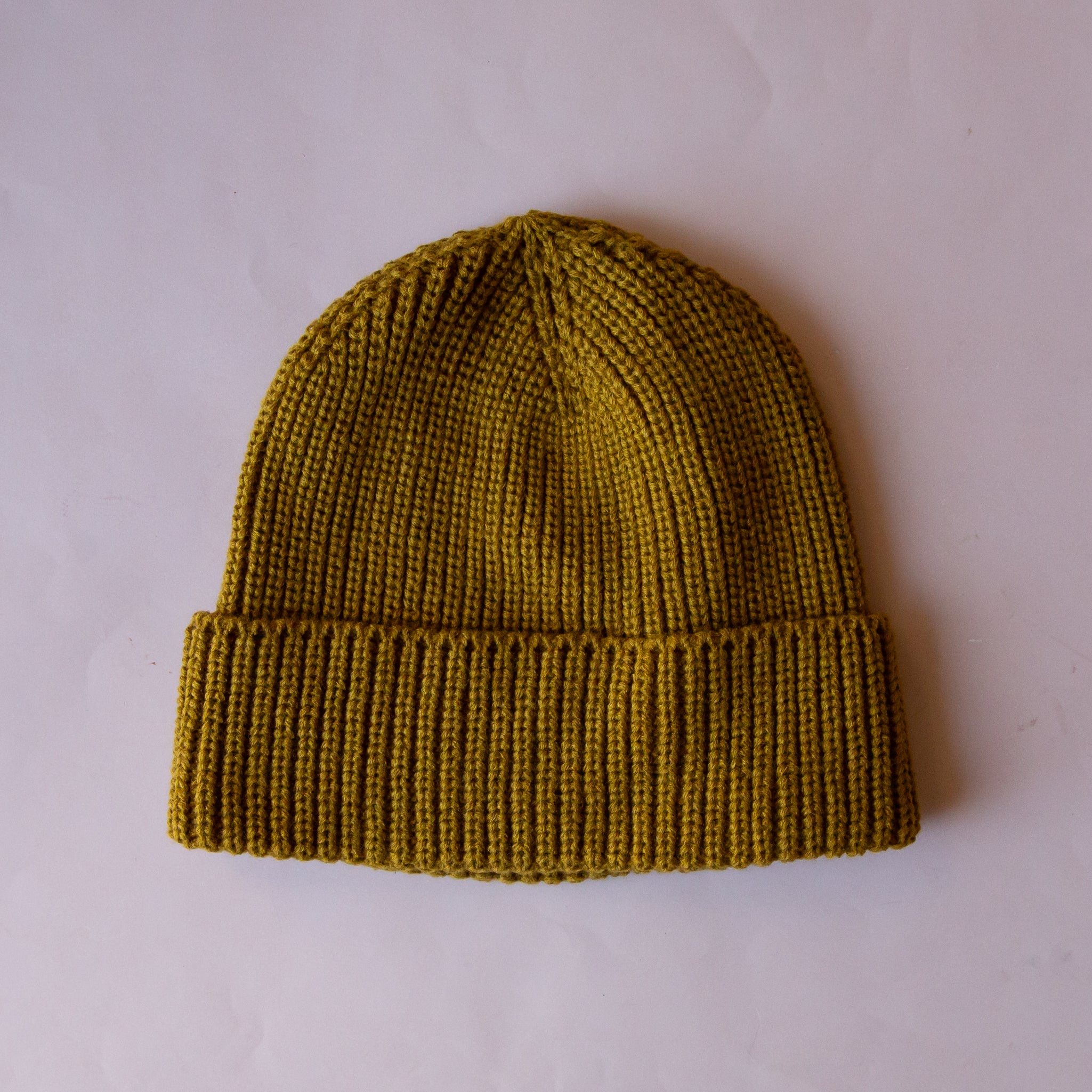 An olive green knit beanie. 