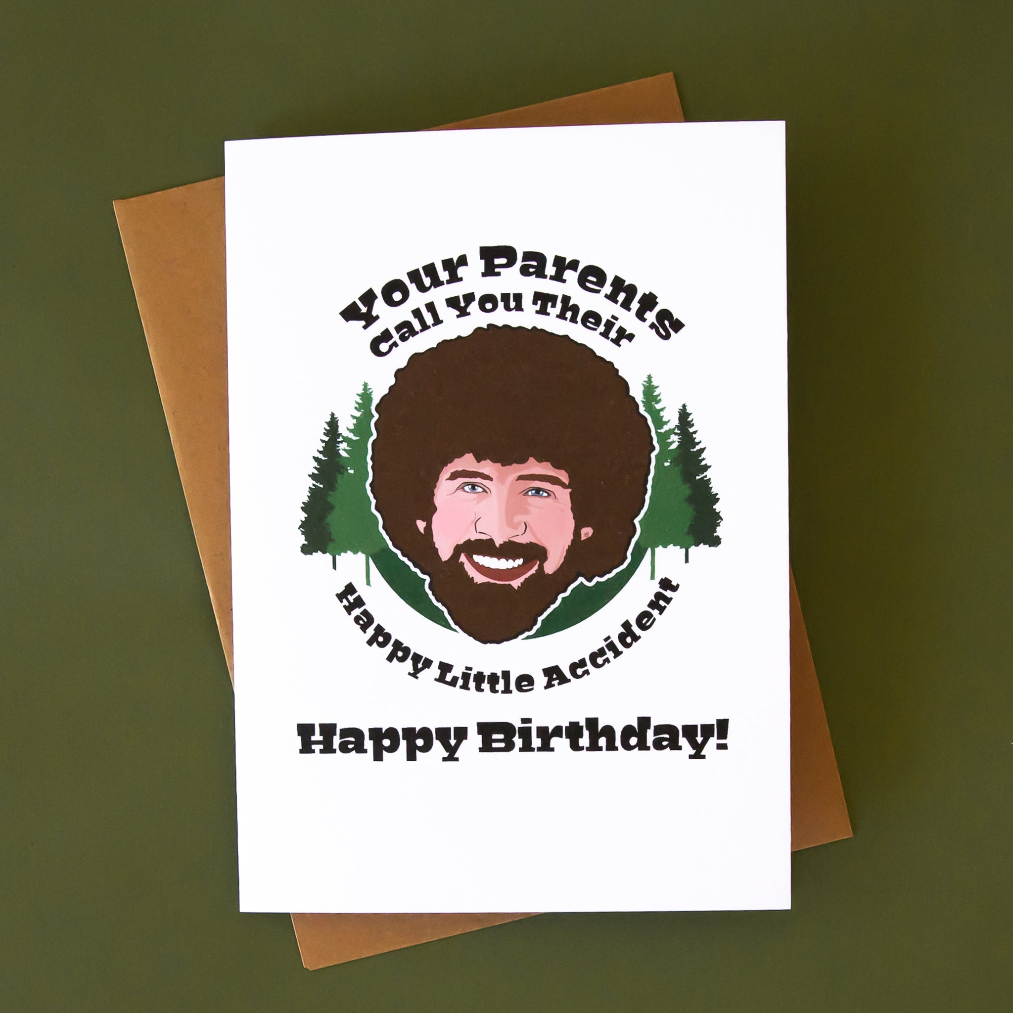 A white card with an illustration of Bob Ross and black text above and below that reads, 'Your parents call you their happy little accident happy birthday'. 