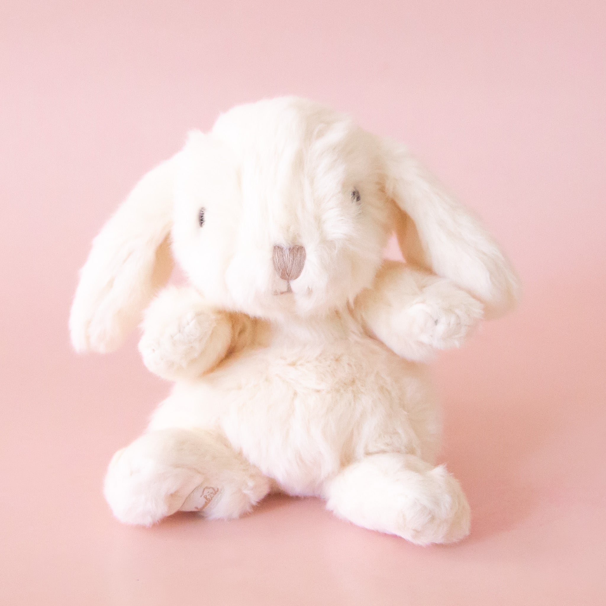 A small white bunny shaped stuffed animal toy. 