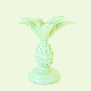 A pineapple palm tree shaped taper candle holder in a mint green shade.