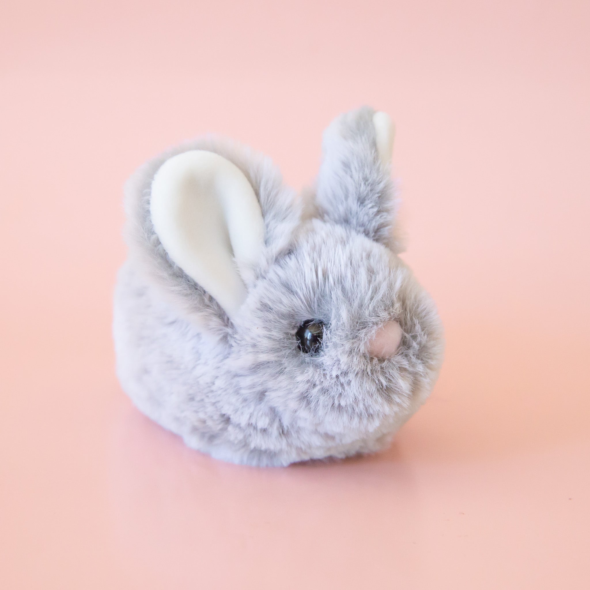 A small grey bunny stuffed animal. 