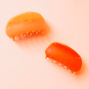 A two-toned rounded claw clip in shades of orange.