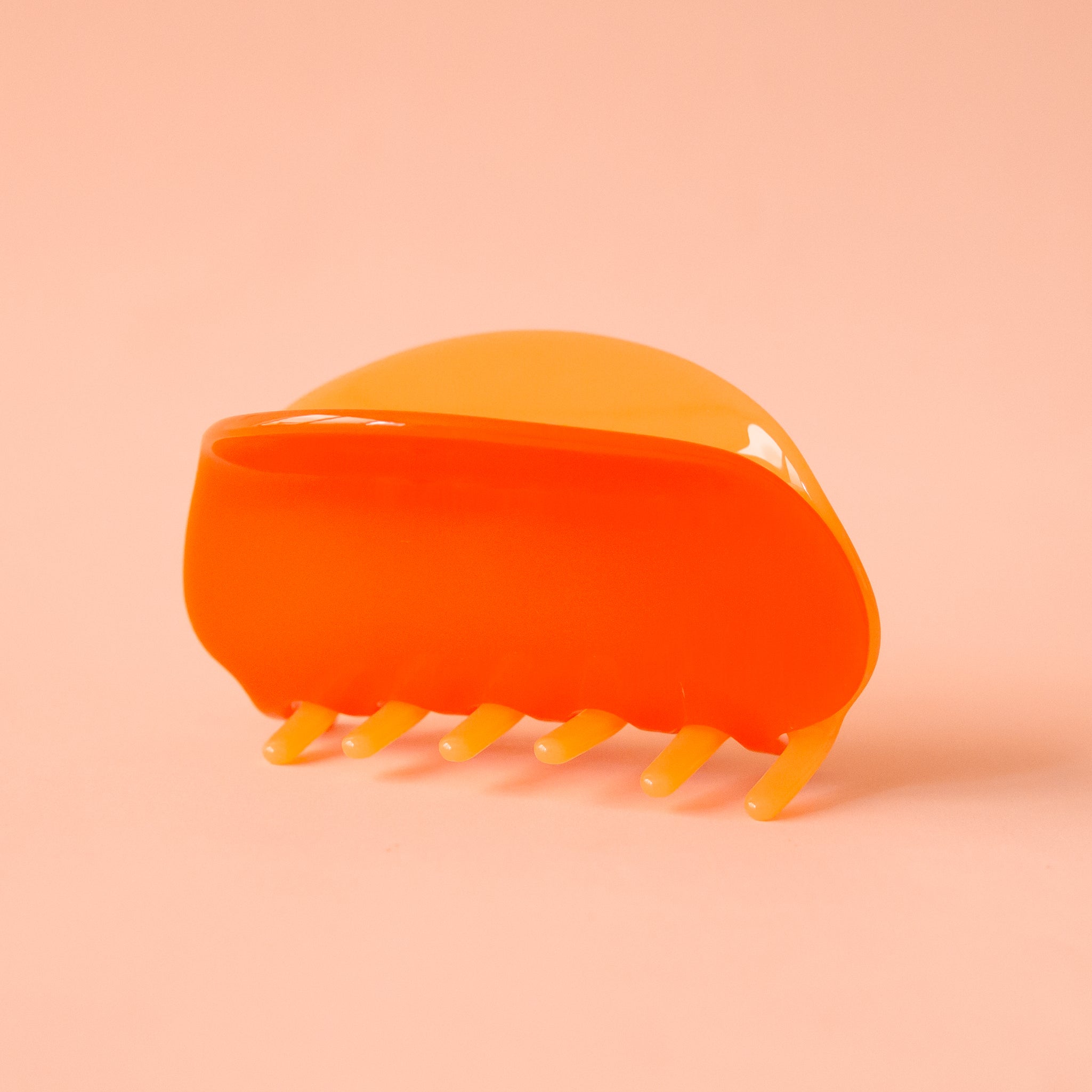 A two-toned rounded claw clip in shades of orange.
