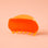 A two-toned rounded claw clip in shades of orange.