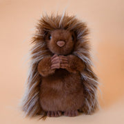 A porcupine shaped stuffed animal. 
