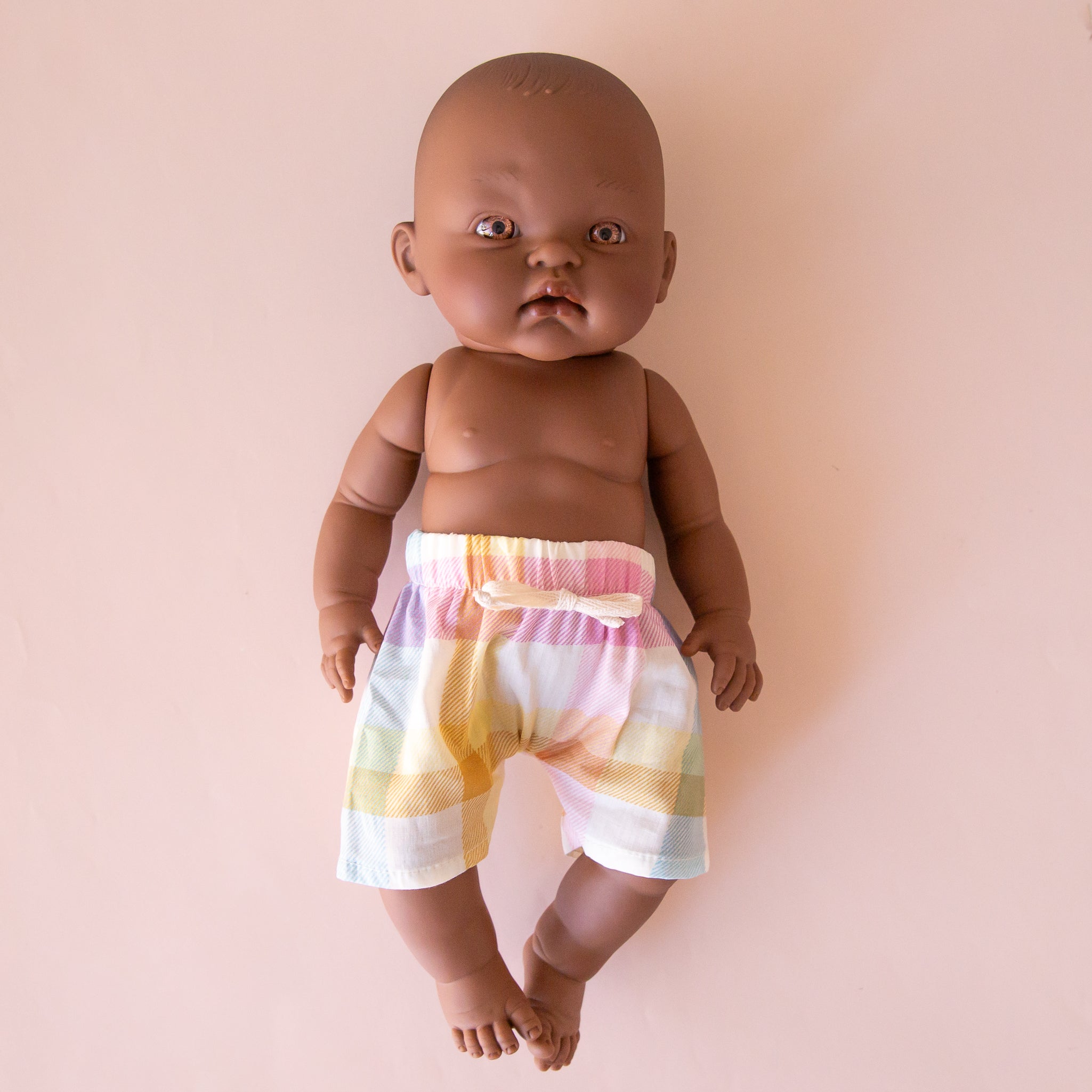 A pair of pastel checkered shorts on a Minikane doll that is sold separately. 
