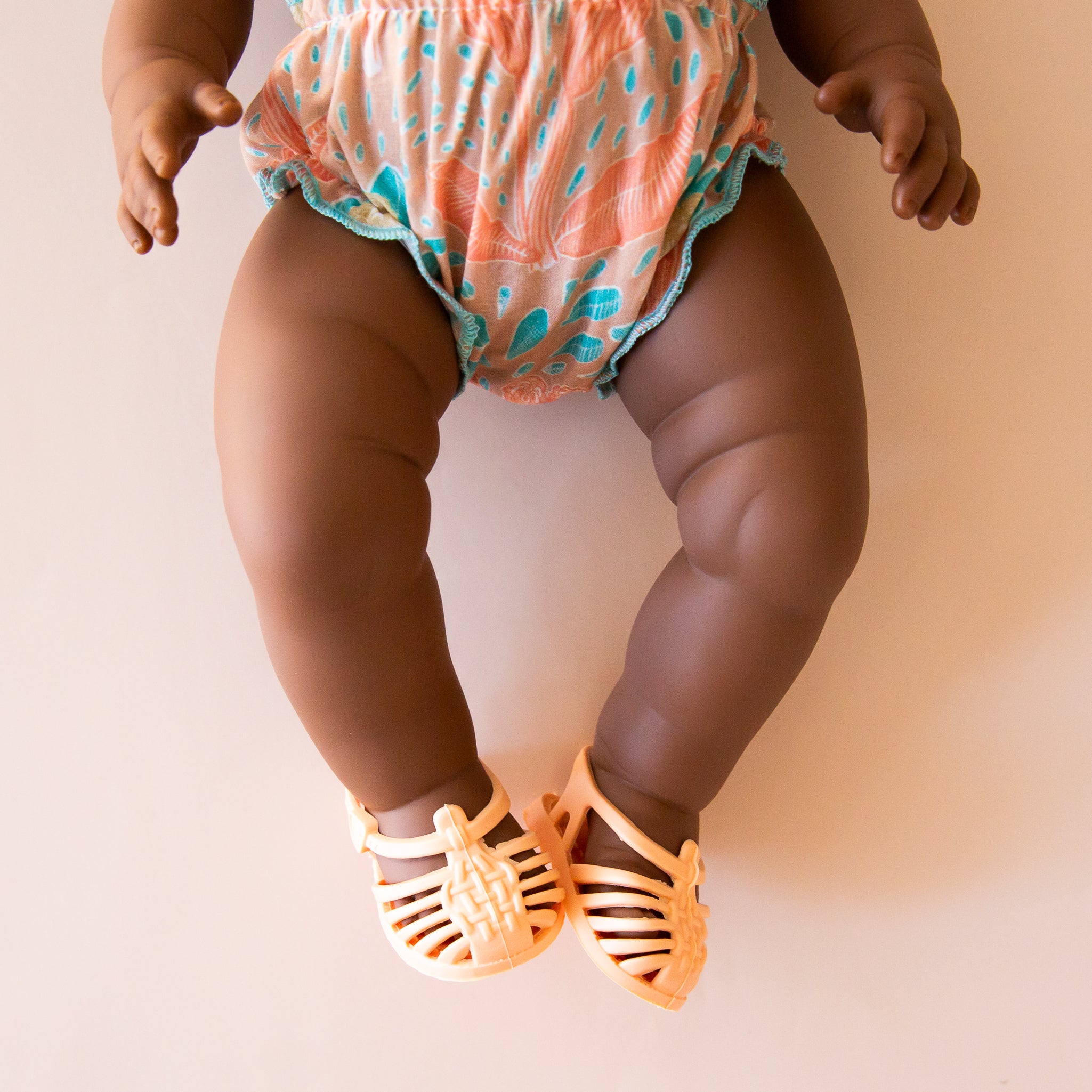 A coral and blue two piece swim suit for Minikane dolls. Dolls sold separately.