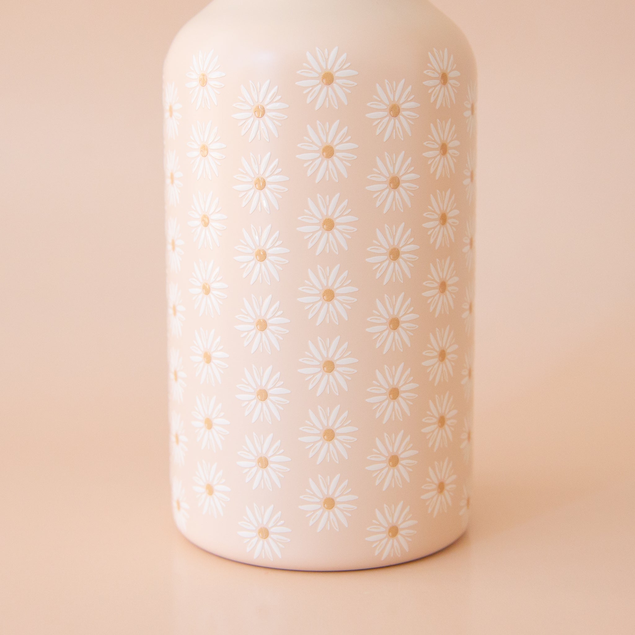 On a peachy background is a floral printed water bottle.