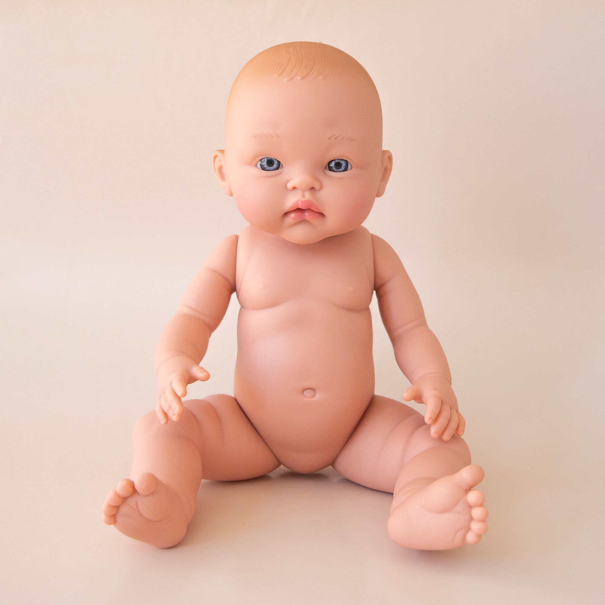 A baby doll with reddish hair and blue eyes. 