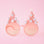 On a pink background is a pair of holiday glasses with tree shapes and six white pom poms and a star on top.