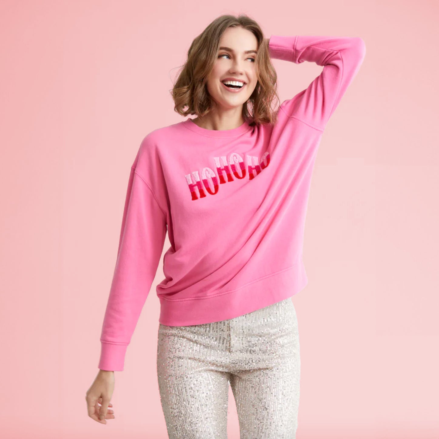 A hot pink crewneck sweatshirt with hot pink and light pink &quot;Ho Ho Ho&quot; across the front.