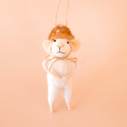 A white felt mouse ornament wearing a orange mushroom shaped hat. 