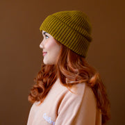 An olive green knit beanie. 