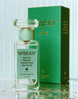 A box of perfume and a clear bottle with a teal blue label on the front that reads, "After Sun Scent of the Illustrious".