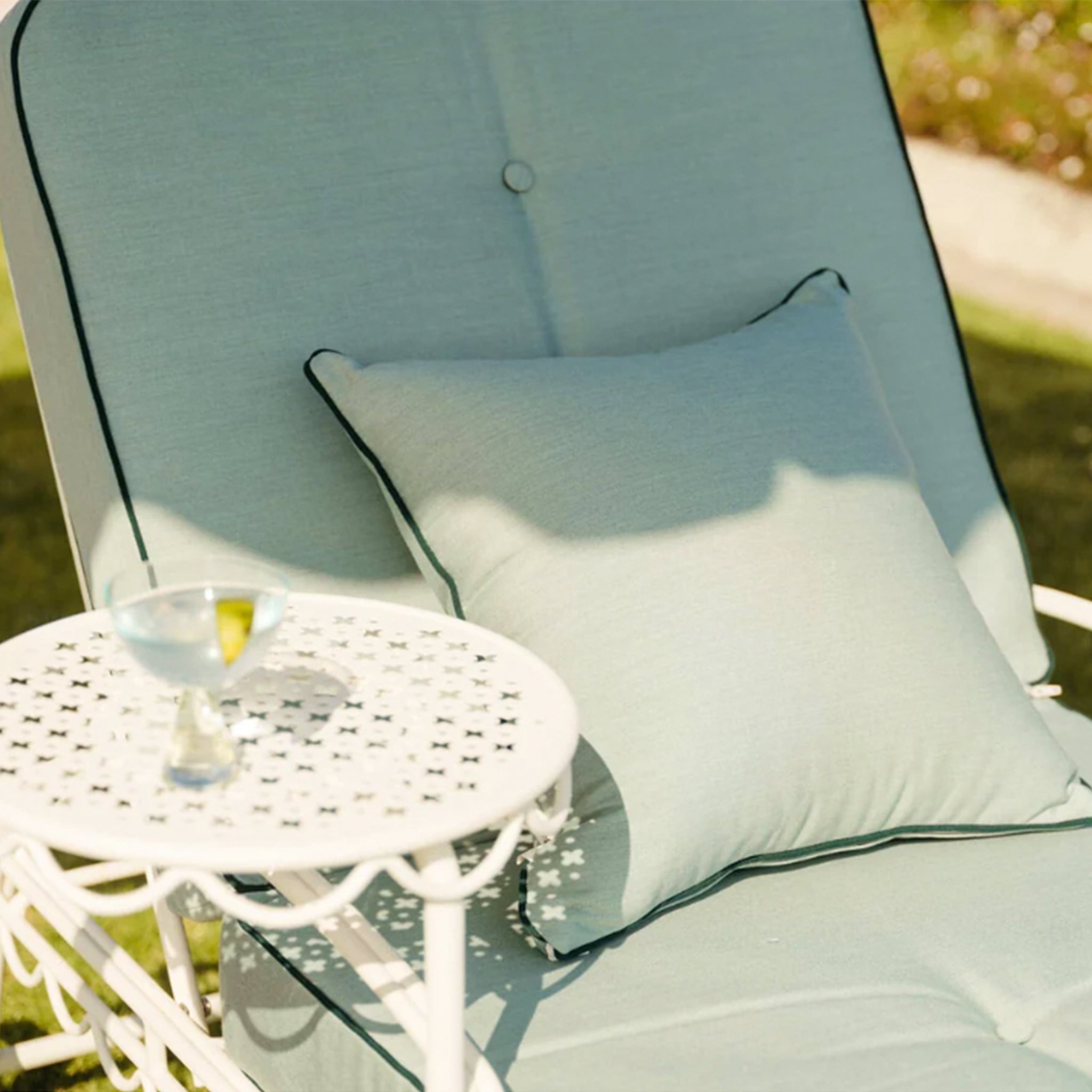 A green lounge cushion with a darker green border around the edges. Lounge chair base and staging props sold separately.