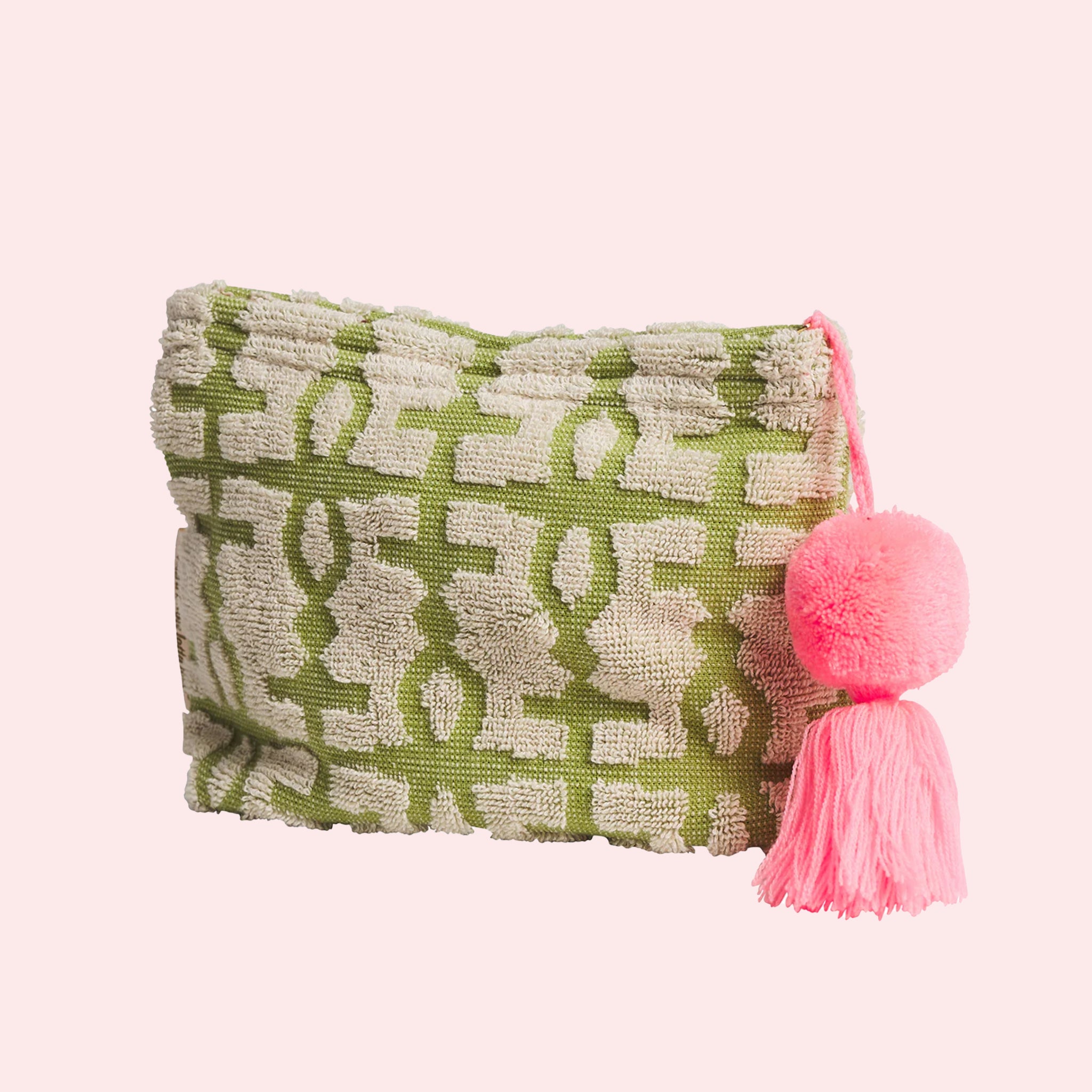 A green and ivory terry cloth pouch with a pink tassel. 