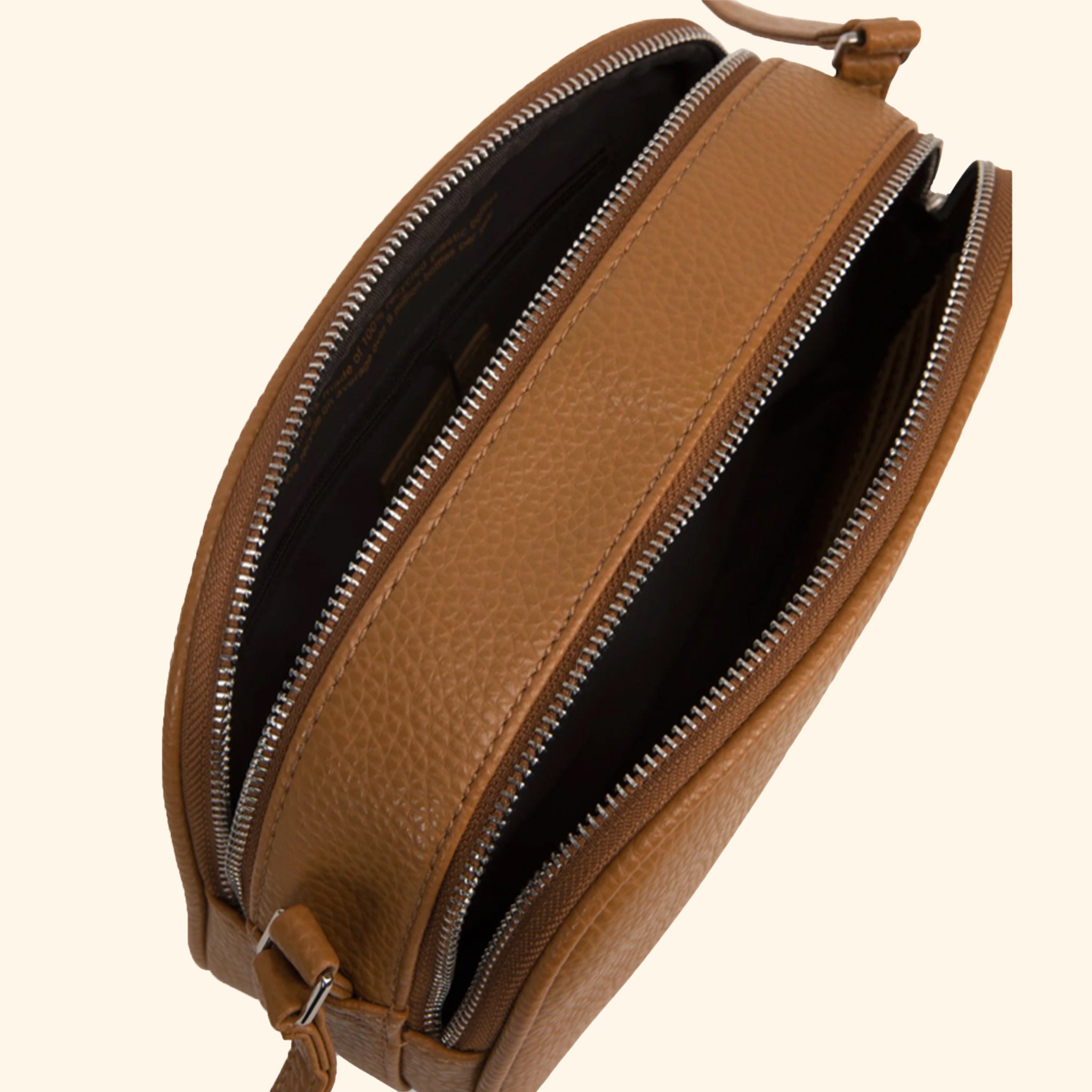 A brown crossbody bag with an adjustable strap and two zipper openings. 