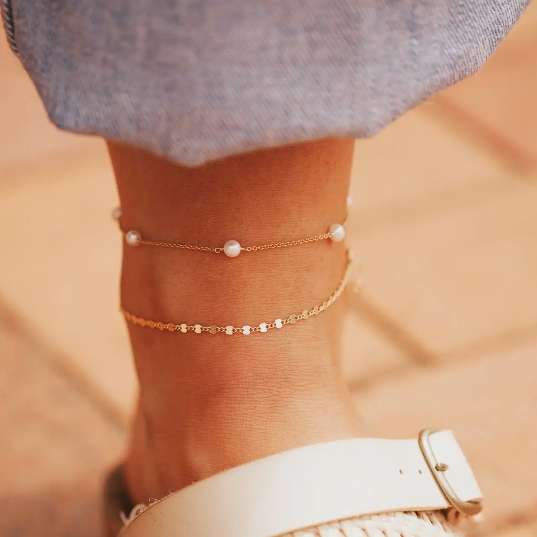 A gold chain anklet. 