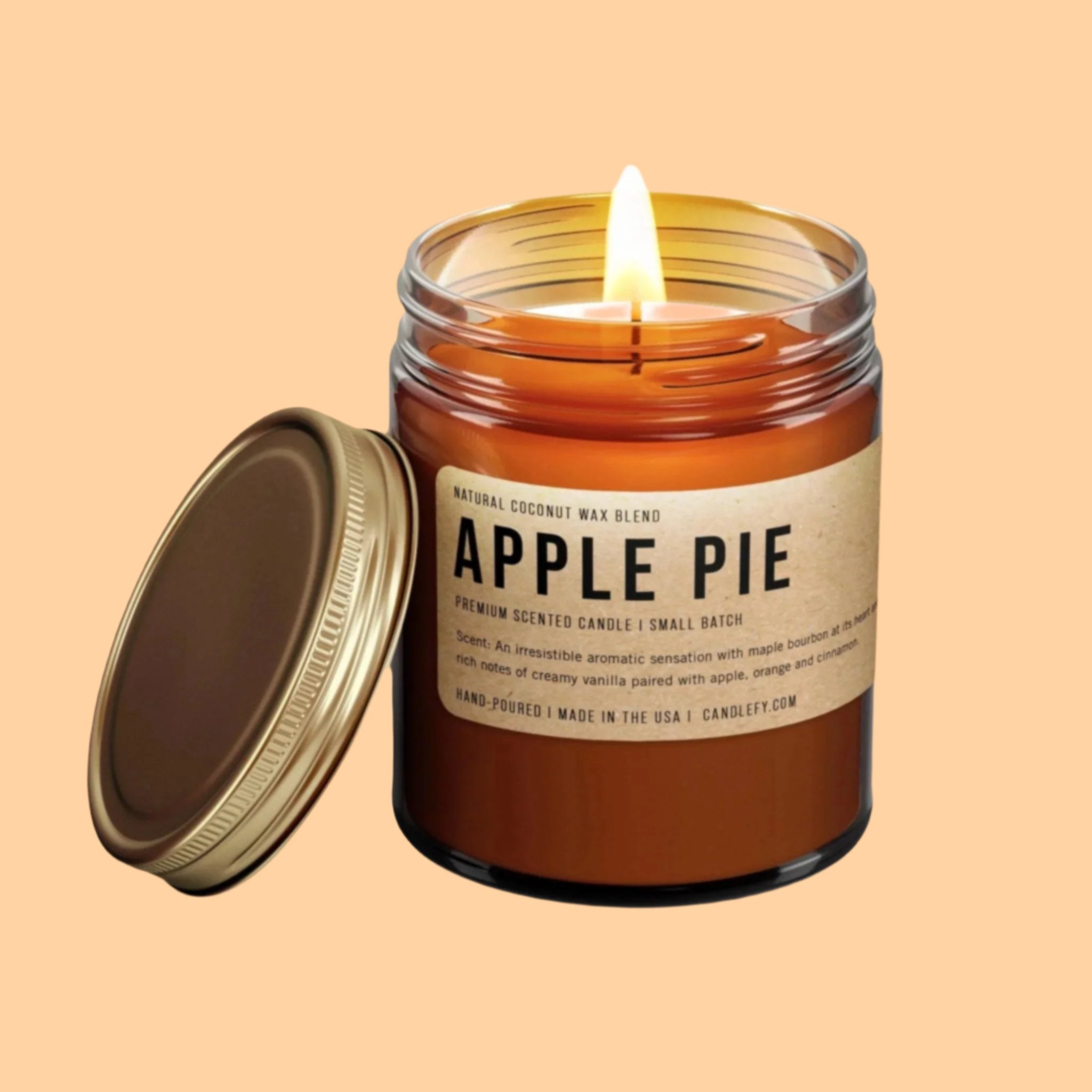 A brown glass jar candle with a brown label that reads, &#39;Apple Pie&#39; in black text. 