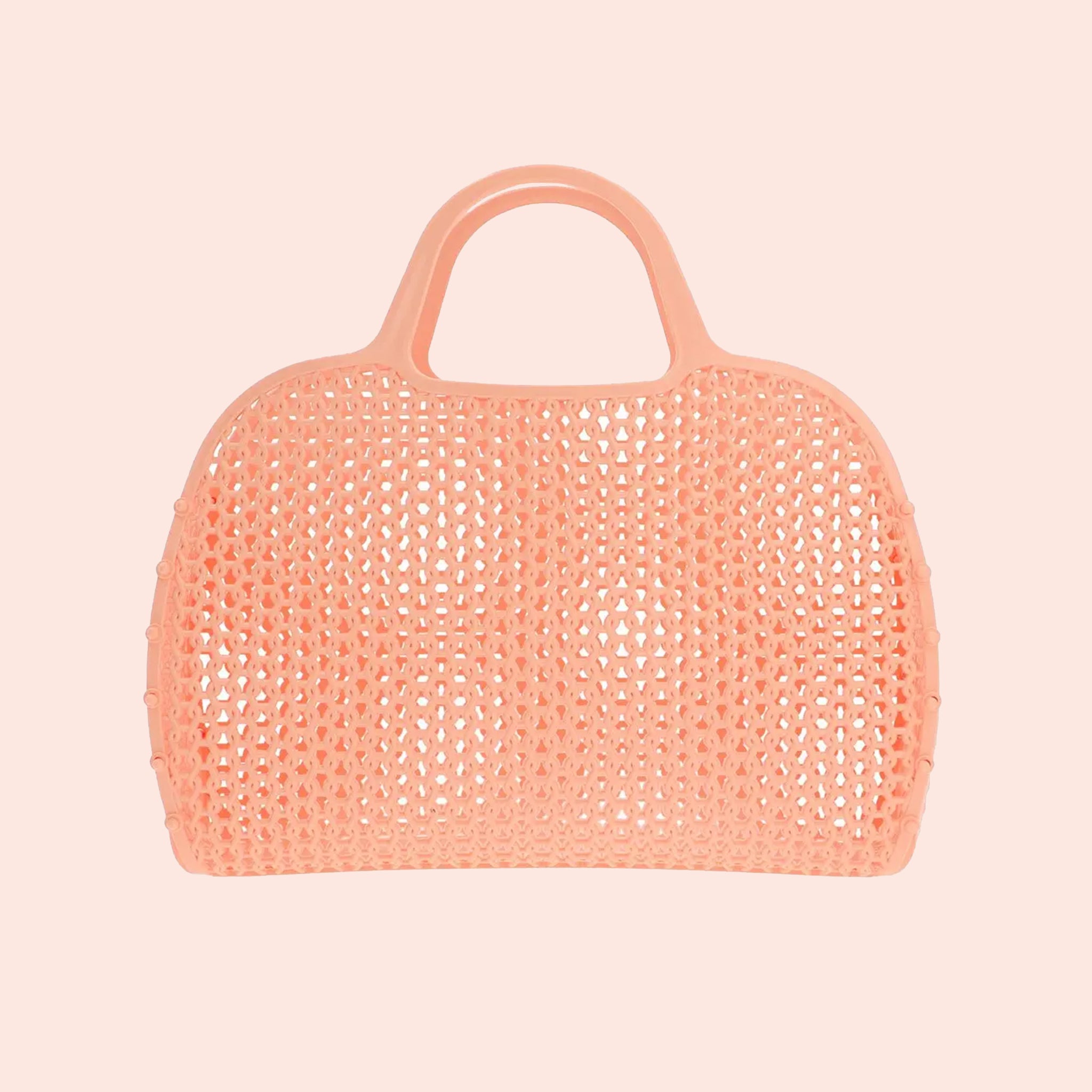 An apricot colored woven plastic handbag with two handles. 