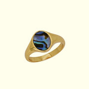 A gold ring with an abalone shell resin. 