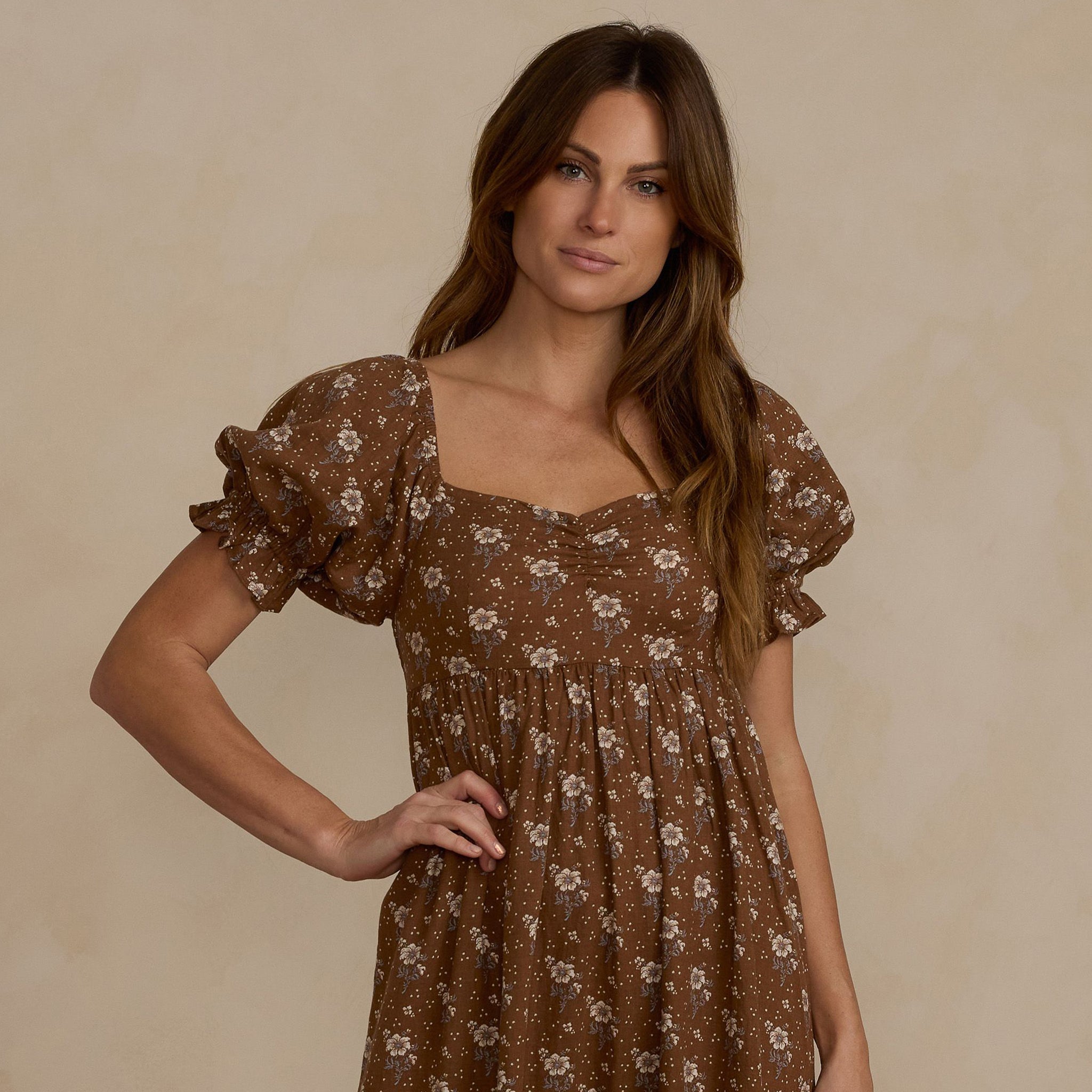 A brown floral maxi dress with puff sleeves. 