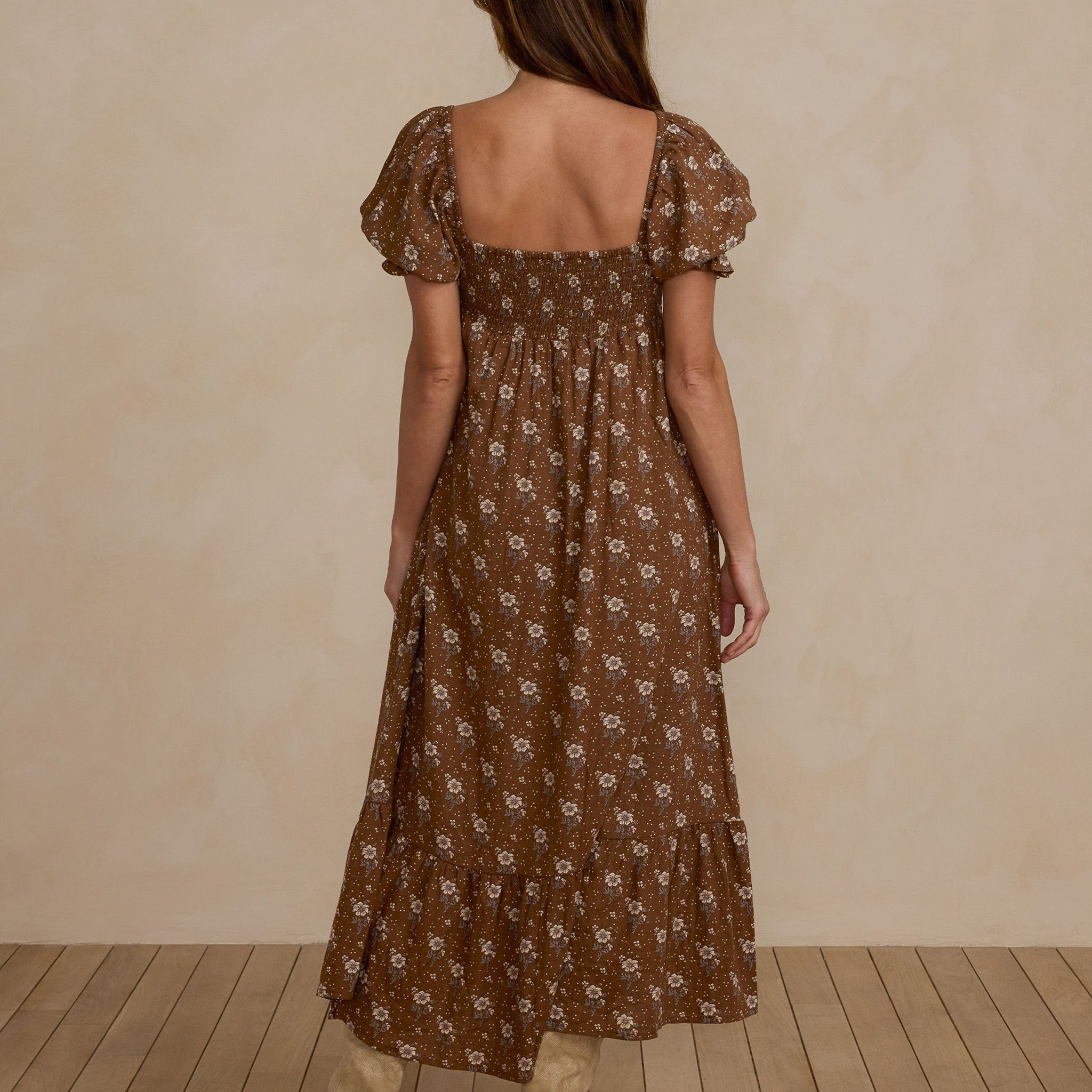 A brown floral maxi dress with puff sleeves.