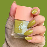 A square bottle of green nail polish.