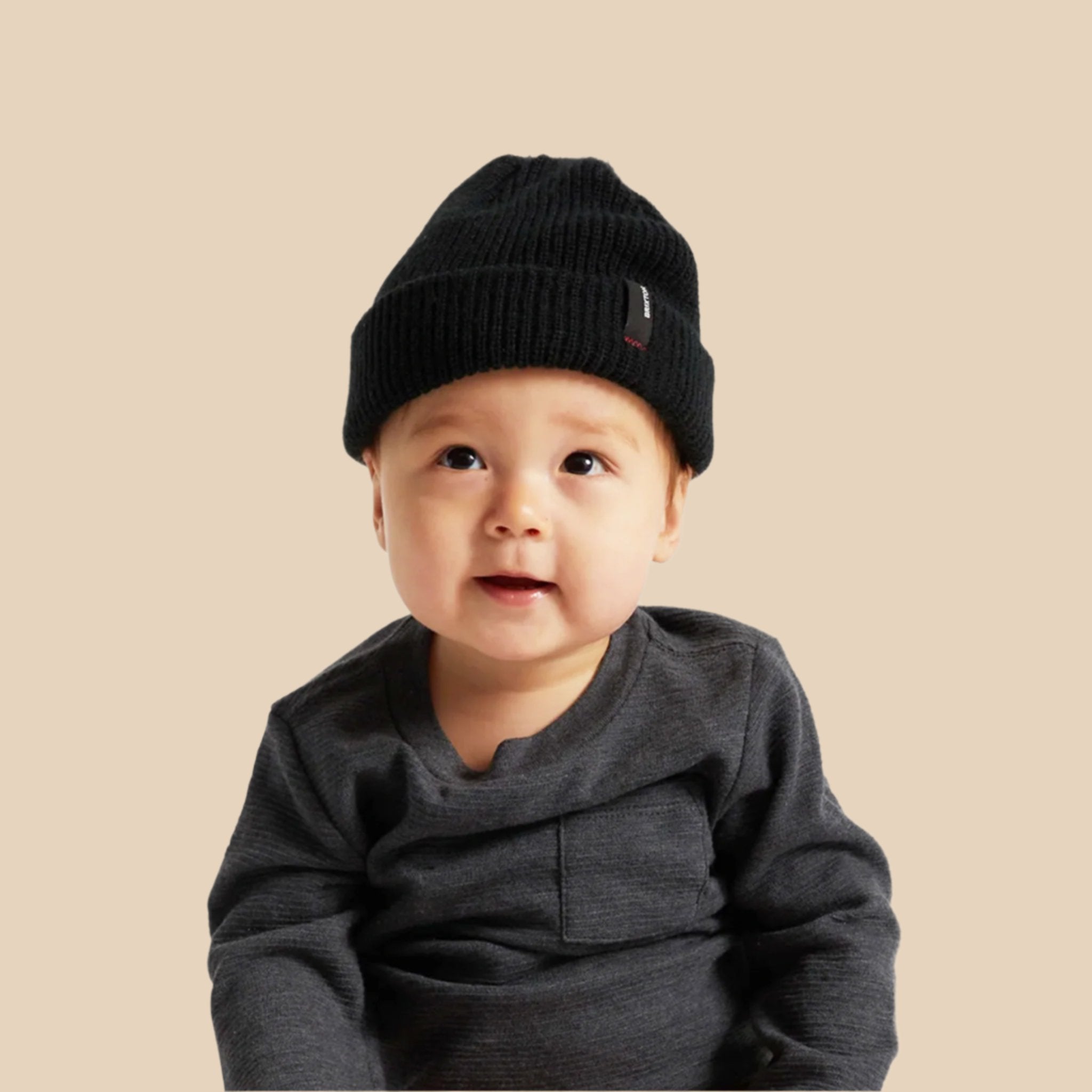 A black beanie on a baby. 