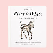 A white children's book with a graphic of a black and white zebra and text that reads, 'Baby's Black & White Contrast Book'. 