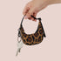 a tiny leopard print crescent bag charm with a keychain attachment.