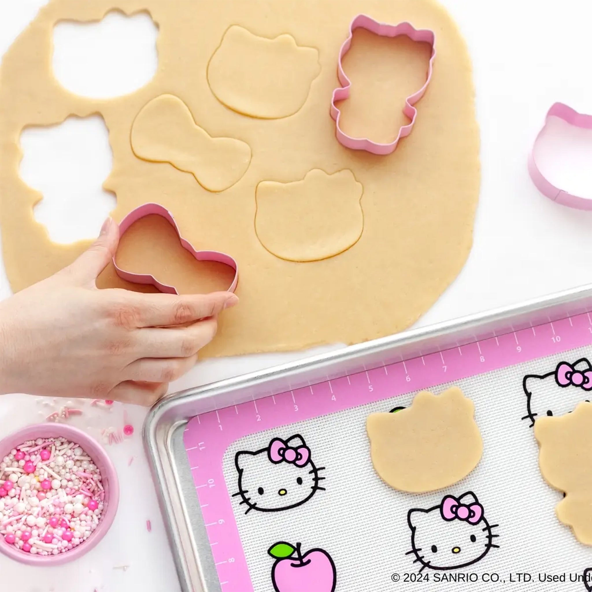 A set of baking accessories in hello kitty shapes and designs.