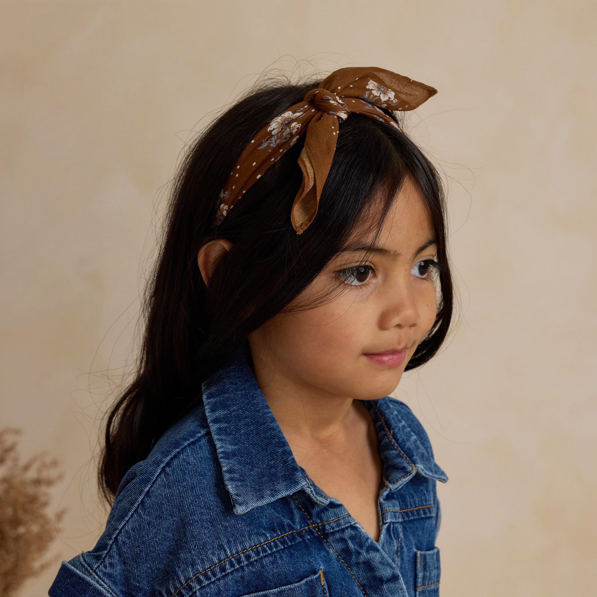 A brown bandana with a floral print.