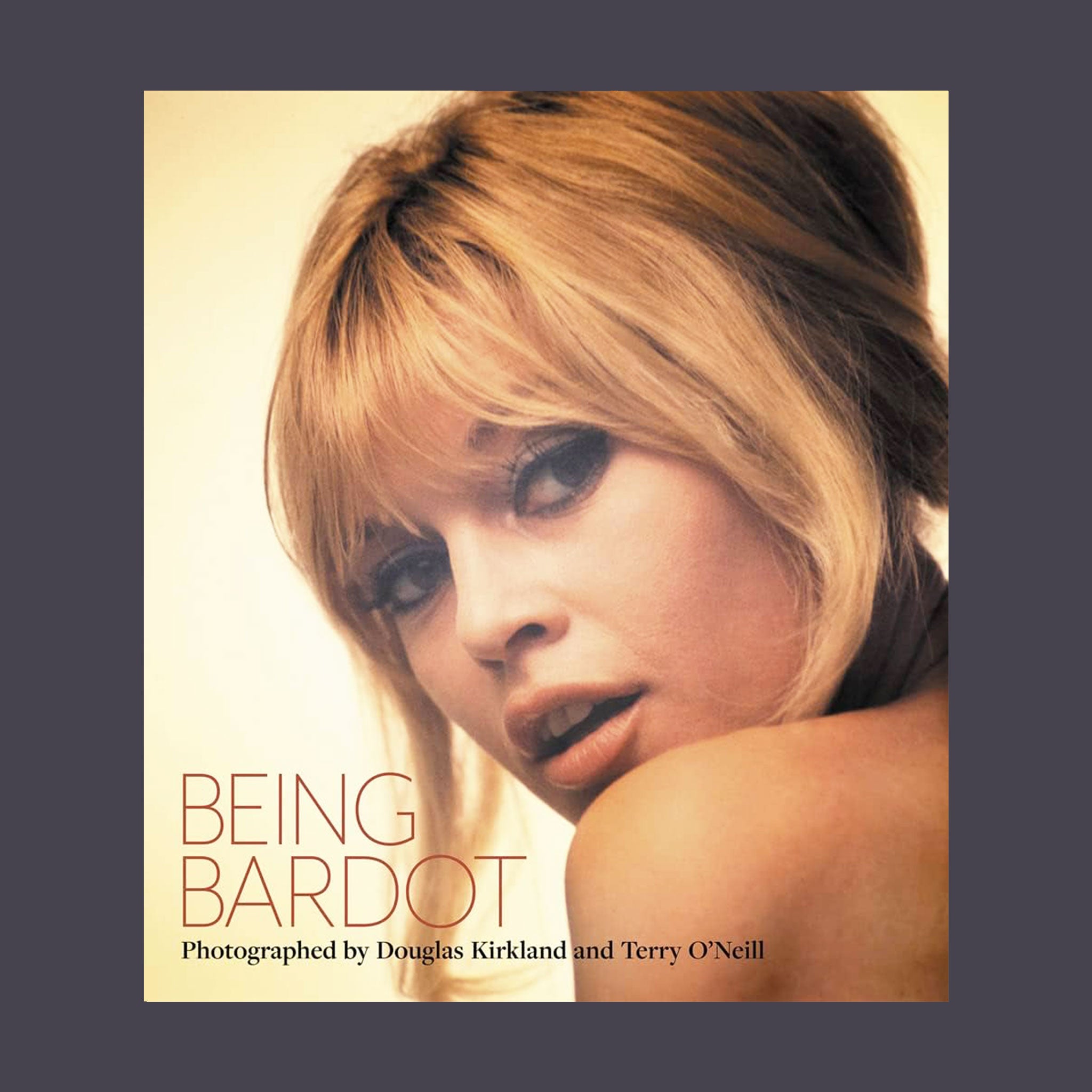 On a light tan background is an ivory book with a photo of Brigitte Bardot.  