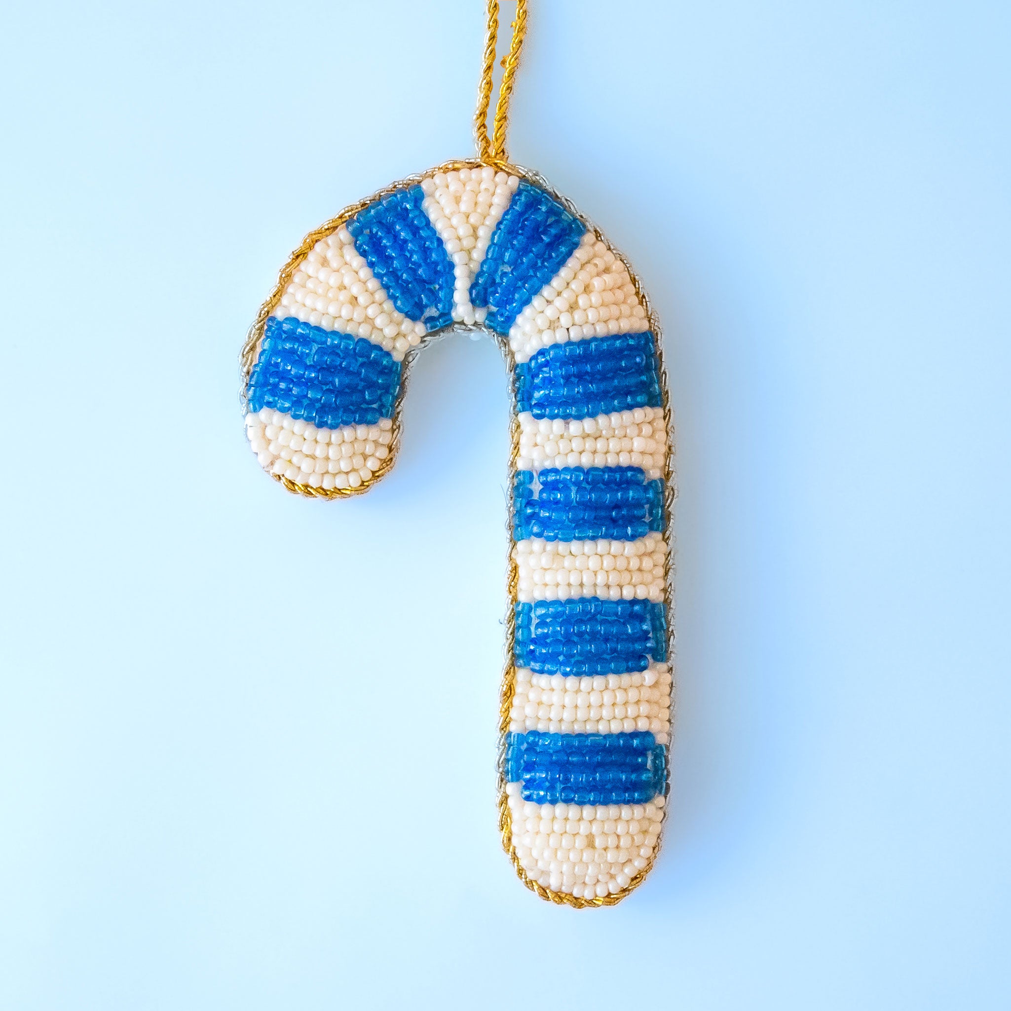 A blue and white beaded candy cane ornament. 