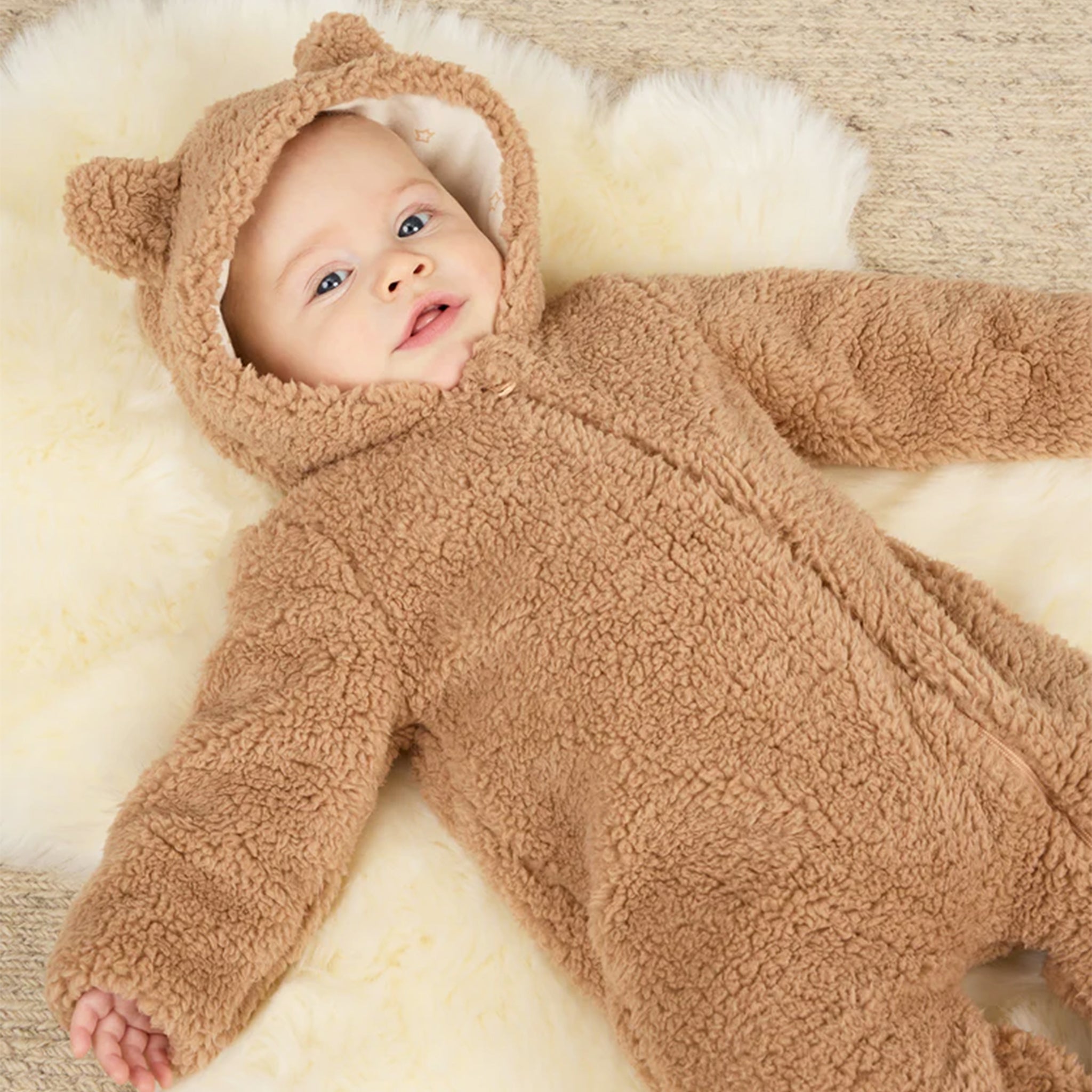 A fuzzy brown jumpsuit with a hood with bear ears on it. 