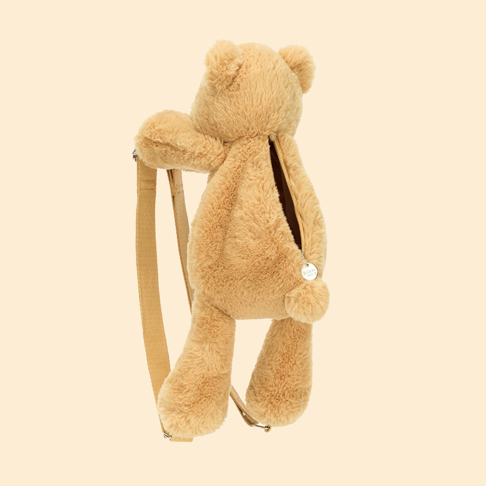 A neutral bear shaped backpack with two straps with silver details.